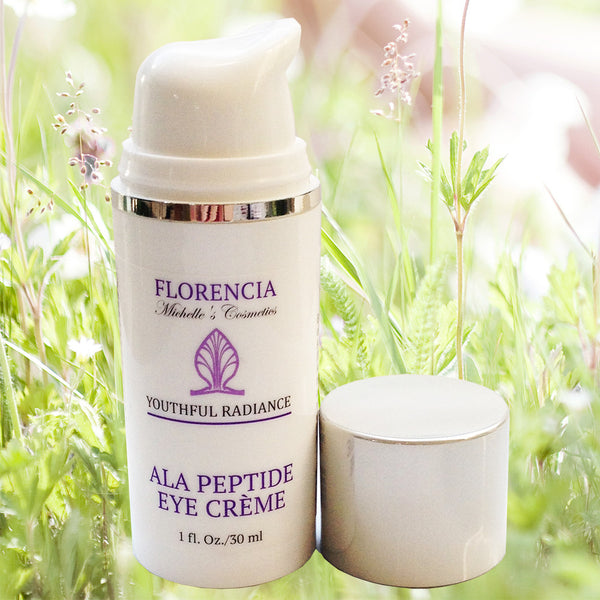 ALA Peptide Eye & Neck Cream bottle with wild flowers in the background.