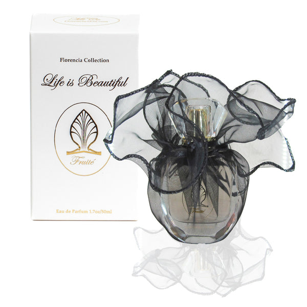 Fruité Perfume bottle wrapped up in a transparent black gift bag in front a perfume box.