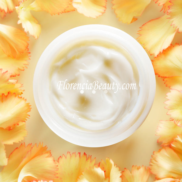 Arial image of Papaya & Pumpkin Brightening Exfoliating Mask in a jar surrounded by petals.