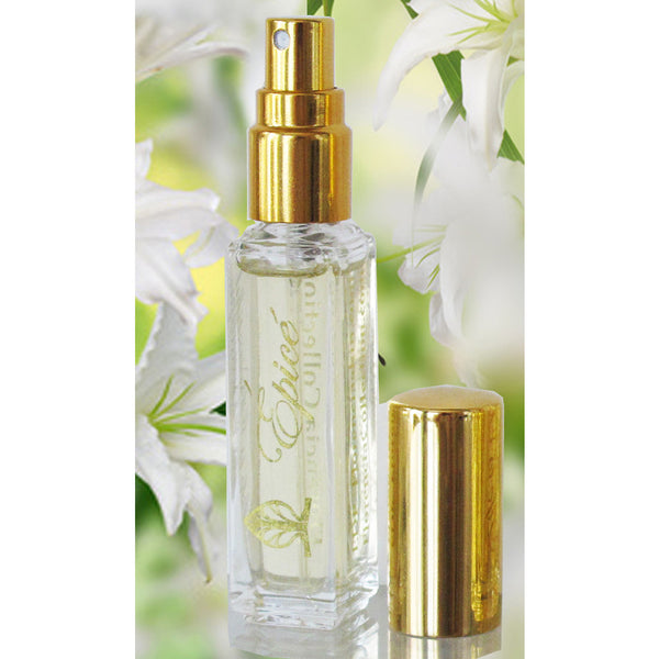 A bottle of Épicé Fragrance spray with a clear bottle and gold spray and a gold lid sitting next to the bottle.