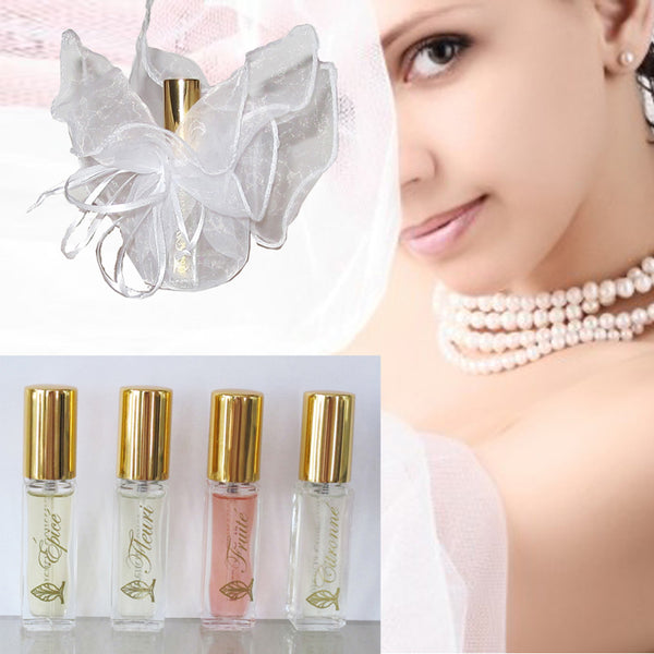 Five bottles of perfume. A bottle of perfume wrapped in a transparent white gift bag.